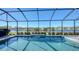 Take a refreshing dip in the screened pool, overlooking a tranquil lake at 1825 Twin Rivers Trl, Parrish, FL 34219