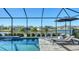 Relax by the refreshing pool and enjoy the serene lake view from this screened-in patio area at 1825 Twin Rivers Trl, Parrish, FL 34219