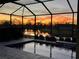 Enclosed pool area with lake view and sunset view at 1825 Twin Rivers Trl, Parrish, FL 34219