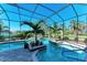 Inviting screened pool and spa with lush landscaping at 197 Grand Oak Cir, Venice, FL 34292