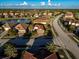 House in a Florida neighborhood with similar homes and a lake nearby at 20680 Vita Ct, Venice, FL 34293