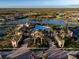 Community clubhouse with pool, palm trees, and ample parking at 20680 Vita Ct, Venice, FL 34293