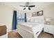 Cozy bedroom featuring two twin-size beds and teal curtains at 20680 Vita Ct, Venice, FL 34293