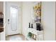 Front entry with glass door and console table, featuring sunflower artwork at 20680 Vita Ct, Venice, FL 34293