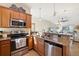 Modern kitchen with stainless steel appliances and granite countertops at 20680 Vita Ct, Venice, FL 34293