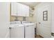 Laundry room with washer, dryer, and upper cabinets at 20680 Vita Ct, Venice, FL 34293