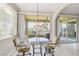 Bright breakfast nook with glass table and chairs, offering water views from sliding doors at 2251 Jessie Harbor Dr # 2101, Osprey, FL 34229
