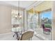 Casual breakfast nook with glass-top table and chairs near balcony with water views at 2251 Jessie Harbor Dr # 2101, Osprey, FL 34229