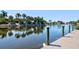 Wooden dock extending into calm waterway with lush foliage at 2251 Jessie Harbor Dr # 2101, Osprey, FL 34229