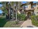 Ground level view of condo building with lush landscaping at 2251 Jessie Harbor Dr # 2101, Osprey, FL 34229