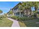 Two-story building with screened balconies and lush landscaping at 2251 Jessie Harbor Dr # 2101, Osprey, FL 34229