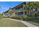 Two-story building with screened balconies and lush landscaping at 2251 Jessie Harbor Dr # 2101, Osprey, FL 34229