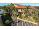 Condo building exterior with parking and tropical landscaping at 2251 Jessie Harbor Dr # 2101, Osprey, FL 34229