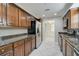 Updated kitchen boasts granite countertops, stainless steel appliances, and rich wood cabinets at 2251 Jessie Harbor Dr # 2101, Osprey, FL 34229
