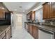 Modern kitchen features granite countertops, stainless steel appliances, and dark wood cabinets at 2251 Jessie Harbor Dr # 2101, Osprey, FL 34229