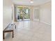 Bright living room with tile floors and ceiling fan, leading to a private balcony with water views at 2251 Jessie Harbor Dr # 2101, Osprey, FL 34229