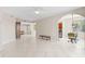 Spacious living room with tile floors, ceiling fan, and access to balcony and dining area at 2251 Jessie Harbor Dr # 2101, Osprey, FL 34229