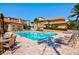 Community pool area with patio furniture and building in background at 2251 Jessie Harbor Dr # 2101, Osprey, FL 34229