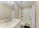 Clean bathroom with white tile, bathtub, and quartz countertop vanity at 227 Cape Harbour Loop # 103, Bradenton, FL 34212