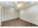 Spacious bedroom with dark wood-look tile floors and ceiling fan at 227 Cape Harbour Loop # 103, Bradenton, FL 34212