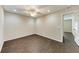 Simple bedroom with dark wood floors and ceiling fan at 227 Cape Harbour Loop # 103, Bradenton, FL 34212