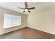 Bright bedroom with wood-look tile flooring and large window with blinds at 227 Cape Harbour Loop # 103, Bradenton, FL 34212