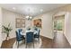 Bright dining room features a chandelier and view into the kitchen at 227 Cape Harbour Loop # 103, Bradenton, FL 34212