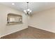 Dining room with dark wood floors and kitchen passthrough at 227 Cape Harbour Loop # 103, Bradenton, FL 34212