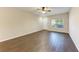 Living room with dark brown tile floor and ceiling fan, access to front door at 227 Cape Harbour Loop # 103, Bradenton, FL 34212