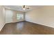 Living room with dark brown tile flooring and a ceiling fan, view of front door at 227 Cape Harbour Loop # 103, Bradenton, FL 34212