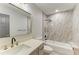 Bathroom featuring a marble shower with bath, modern vanity with gold fixtures and lighting at 2435 Sumatran Way # 35, Clearwater, FL 33763
