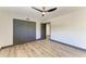 Bedroom featuring hardwood floors, closet with gray doors, ceiling fan, and ensuite access at 2435 Sumatran Way # 35, Clearwater, FL 33763