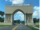 Community entrance with a grand archway and globe feature at 2435 Sumatran Way # 35, Clearwater, FL 33763