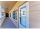 Condo entrance featuring a well-lit exterior hallway, door with glass, and an adjacent window at 2435 Sumatran Way # 35, Clearwater, FL 33763
