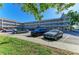 Exterior view of a multi-story condo complex with a well-maintained parking lot and landscaped grounds at 2435 Sumatran Way # 35, Clearwater, FL 33763