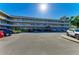 Exterior view of a multi-story condo complex with a well-maintained parking lot at 2435 Sumatran Way # 35, Clearwater, FL 33763