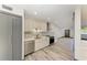 Modern updated kitchen with stainless appliances, stone countertops, and wood flooring at 2435 Sumatran Way # 35, Clearwater, FL 33763