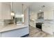 Bright kitchen featuring stainless steel appliances, stone countertops and backsplash, and modern lighting fixtures at 2435 Sumatran Way # 35, Clearwater, FL 33763