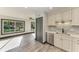 Bright kitchen featuring stainless steel appliances, stone countertops, modern lighting fixtures and wood flooring at 2435 Sumatran Way # 35, Clearwater, FL 33763