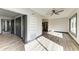 Open-concept featuring hardwood floors, modern ceiling fan, and access to kitchen and bedroom at 2435 Sumatran Way # 35, Clearwater, FL 33763