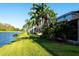 Attractive waterfront view showcasing backyard and palm trees at 294 Fairway Isles Ln, Bradenton, FL 34212