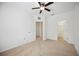 Well lit bedroom with ceiling fan, carpet, and access to closet at 3780 82Nd Avenue E Cir # 106, Sarasota, FL 34243