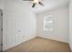 Well-lit bedroom with neutral walls, carpet flooring, and a ceiling fan at 3780 82Nd Avenue E Cir # 106, Sarasota, FL 34243