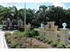 The Oaks Club entrance, featuring a guardhouse, landscaping, and a stately entrance sign at 409 N Point Rd # 704, Osprey, FL 34229