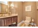 Powder room with decorative wallpaper and dark wood vanity at 415 L Ambiance Dr # A801, Longboat Key, FL 34228
