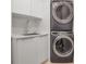 Modern laundry room with stacked washer and dryer at 415 L Ambiance Dr # A801, Longboat Key, FL 34228