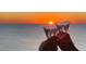 Romantic sunset view with hands toasting with champagne flutes at 415 L Ambiance Dr # A801, Longboat Key, FL 34228