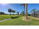 Landscaped backyard with golf course views and screened pool enclosure at 42 Marker Rd, Rotonda West, FL 33947