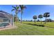Landscaped backyard with golf course view and lush lawn at 42 Marker Rd, Rotonda West, FL 33947