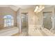Elegant bathroom with double sinks, soaking tub, and shower at 42 Marker Rd, Rotonda West, FL 33947